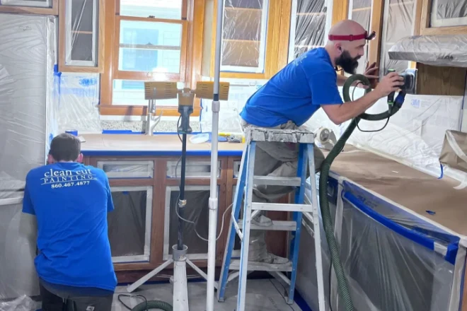 Why The Average Cost Of Interior Painting Varies By Location 6 Clean Cut painters working on a kitchen cabinet painting project. The avergae cost of interior painting does not include specialty jobs like kitchen cabinet painting