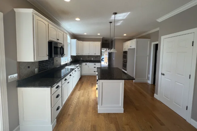 The Ultimate Guide to Kitchen Cabinet Painting in Marlborough, CT 7 A kitchen with gleaming white cabinets professionally painted.