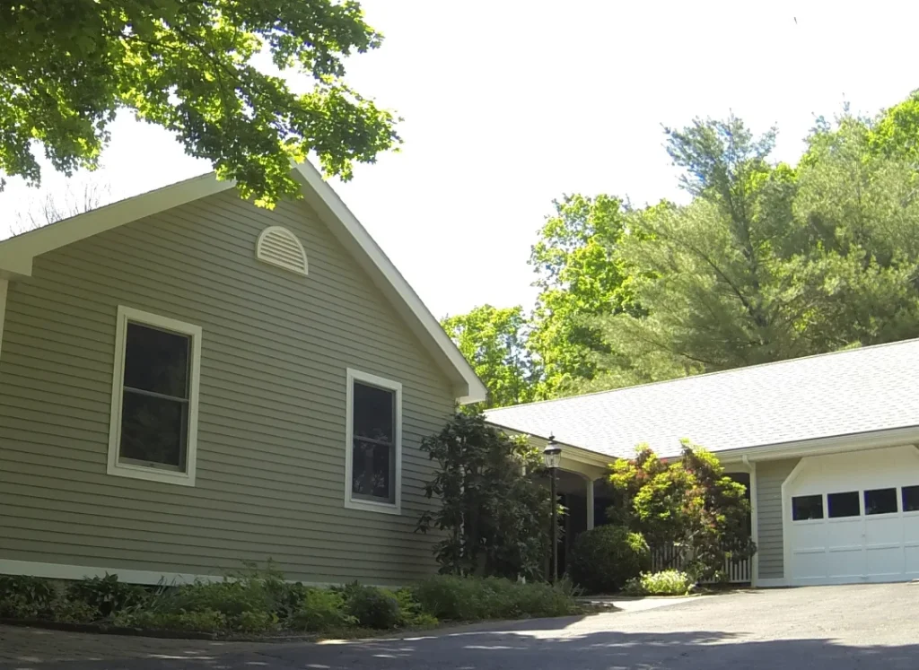 What Is the Best Exterior Paint Sheen? 3 A house with two garages and a driveway.